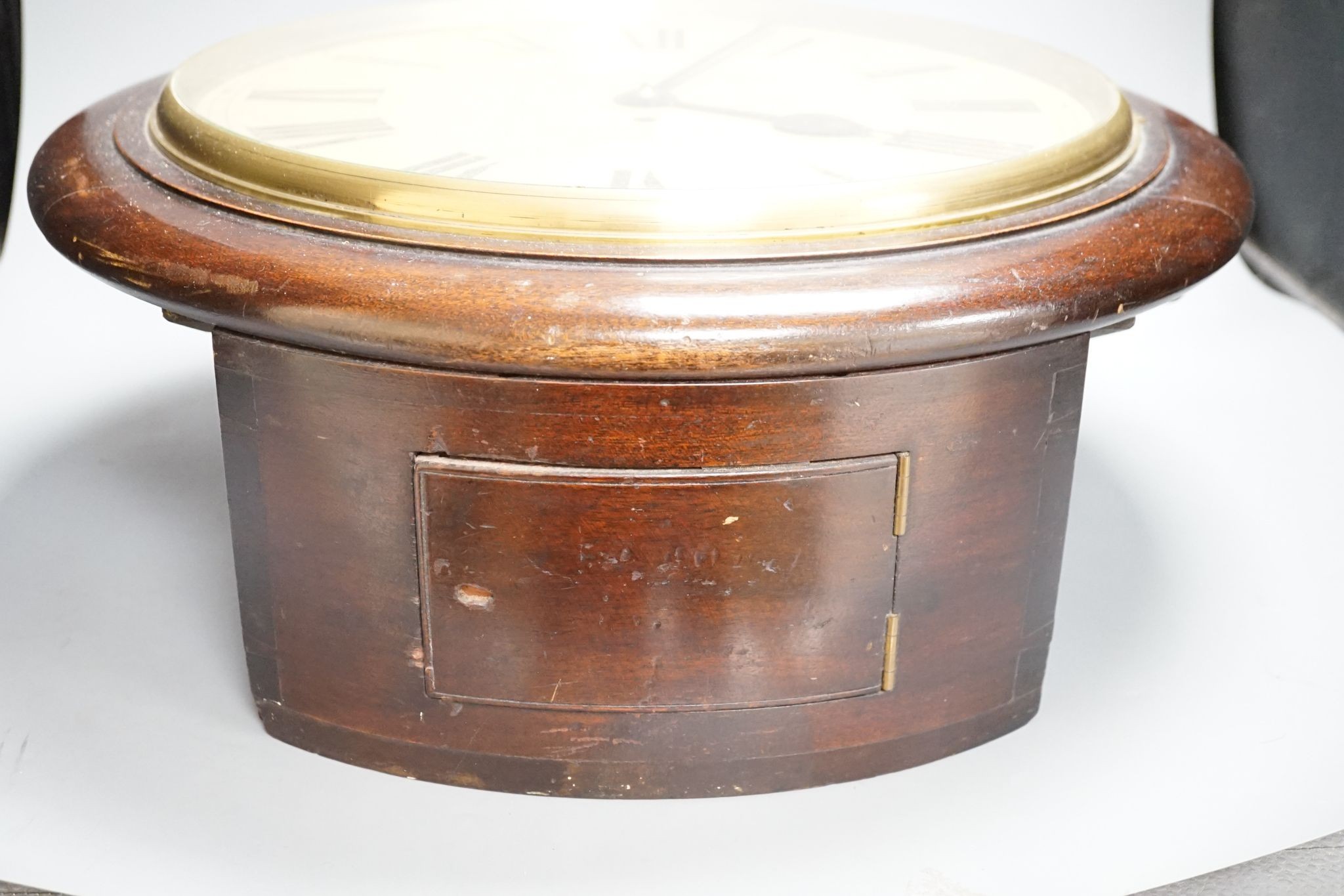 A mahogany dial clock, Marlborough Arms, Sedgmoor Place, London SE5., 48 cms diameter.